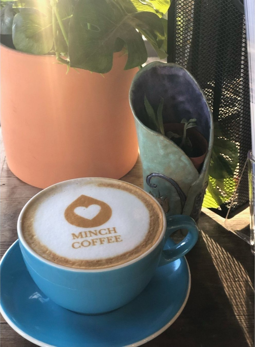 A Minch Coffee latte with the Minch heart logo in the foam