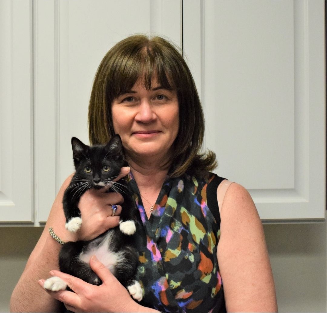 Sandra Cagan holding a black and white kitten